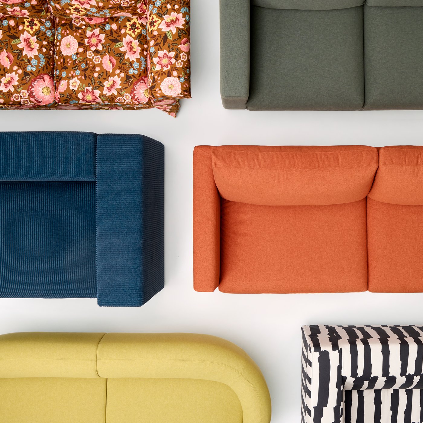 An artful arrangement of six IKEA sofas, placed closely together and starkly varying in colourways and expression.
