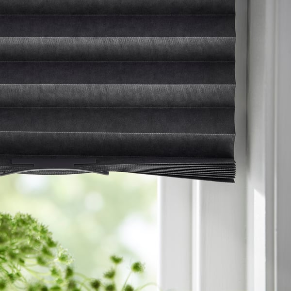 A close up of black pleated cellular blinds.