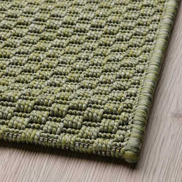 A green MORUM rug flatwoven, in/outdoor