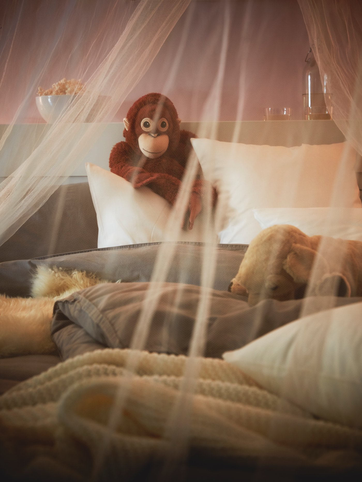 An orangutan DJUNGELSKOG soft toy in the bedroom