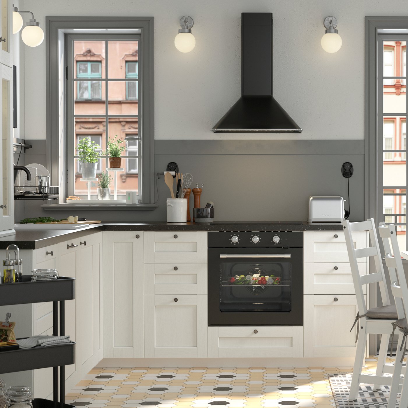 A black and white traditional-style kitchen with a white NORDVIKEN dining table surrounded by three chairs and a pine bench.