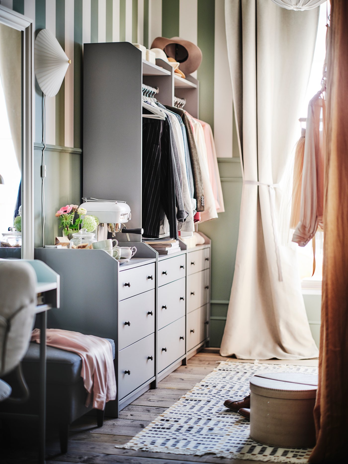 Two grey HAUGA open wardrobes and chest with 3 drawers side by side near a window covered in MAJGULL room darkening curtains.