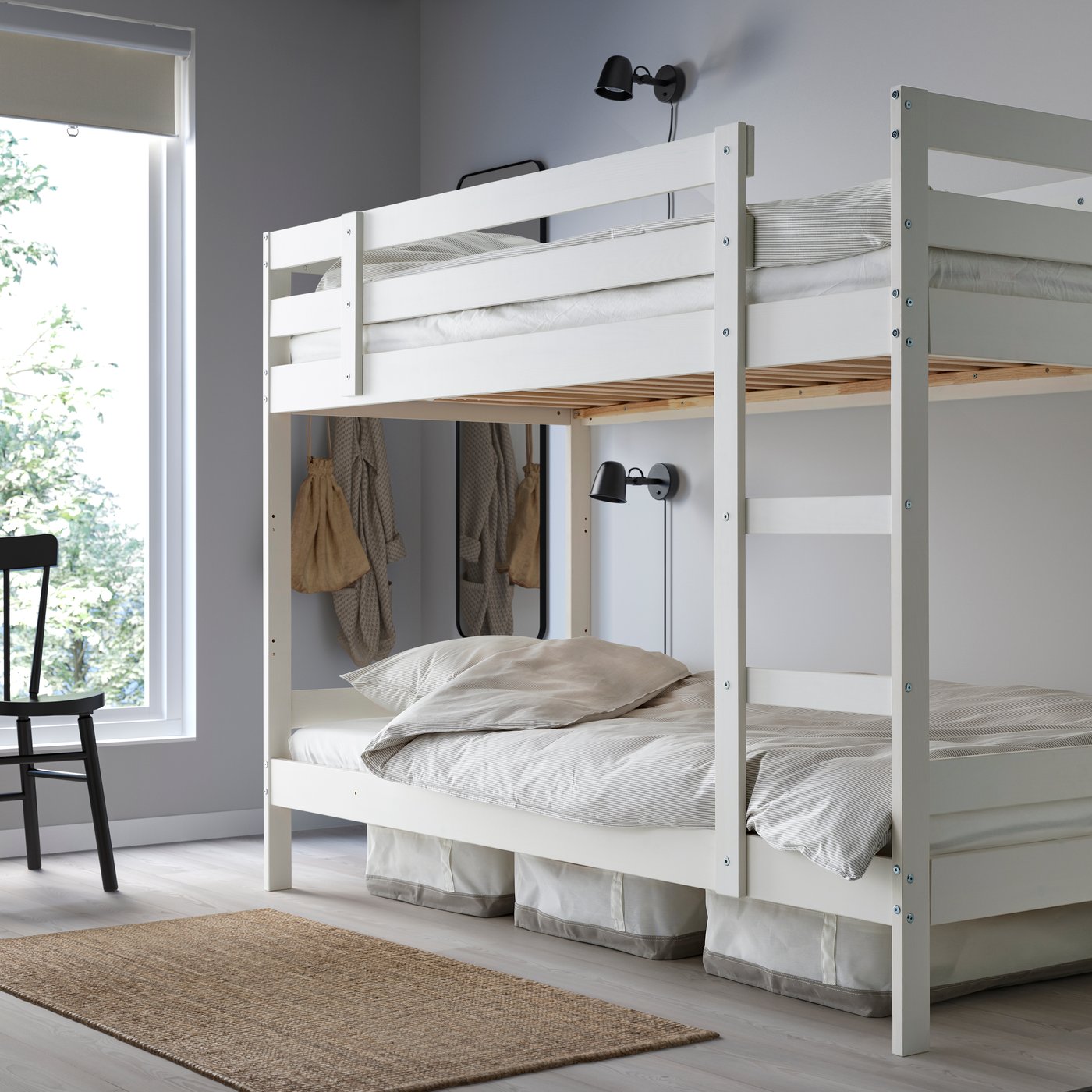 A white MYDAL bunk bed frame