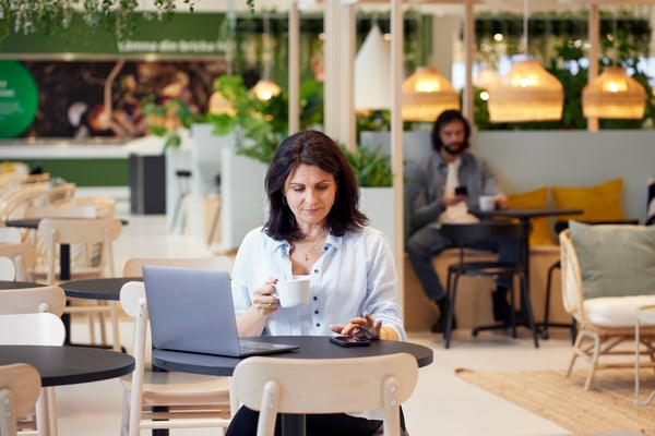 Person drinking a hot drink in the IKEA Swedish Restaurant