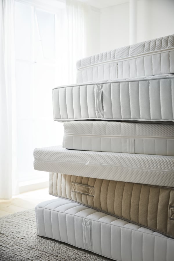 A firm/white ÅBYGDA foam mattress