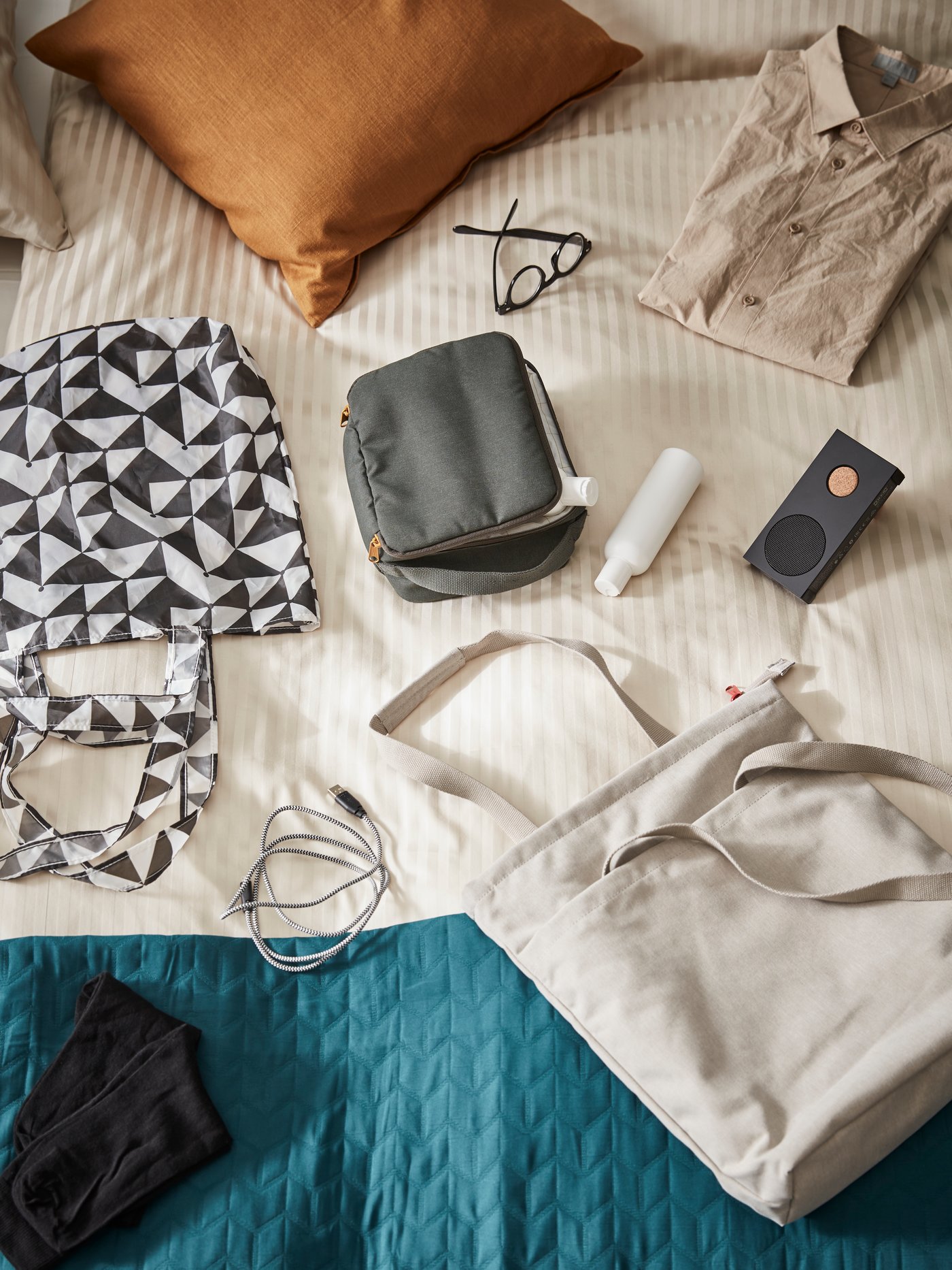 A black ENEBY portable bluetooth speaker in the bedroom