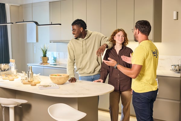 A couple talking to a kitchen specialist at home to plan their kitchen