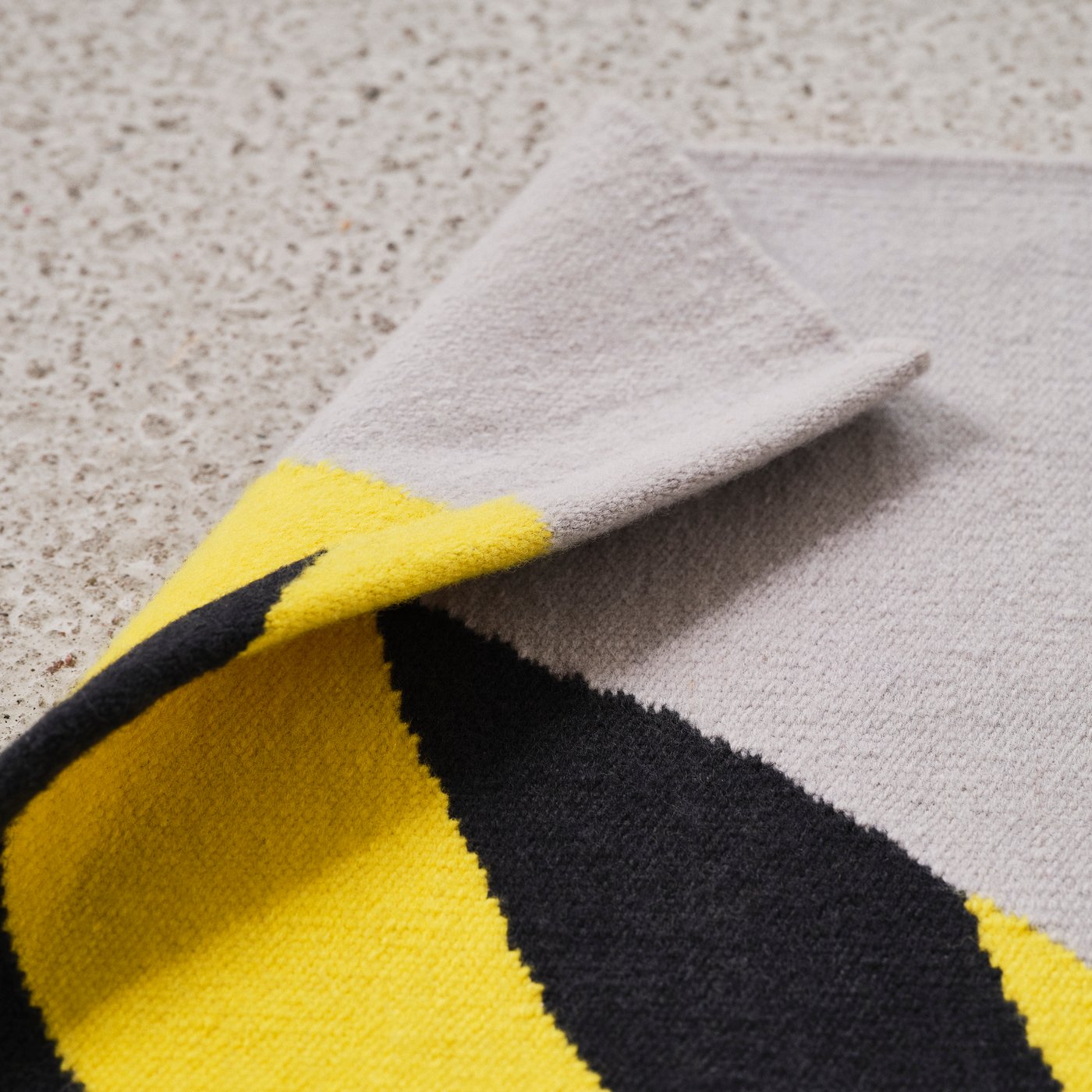 Close up of a black, yellow and grey carpet detail one of the carpets in IKEA KONSTRUNDA art collection.