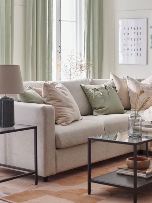 A light green AINA cushion cover in the living room