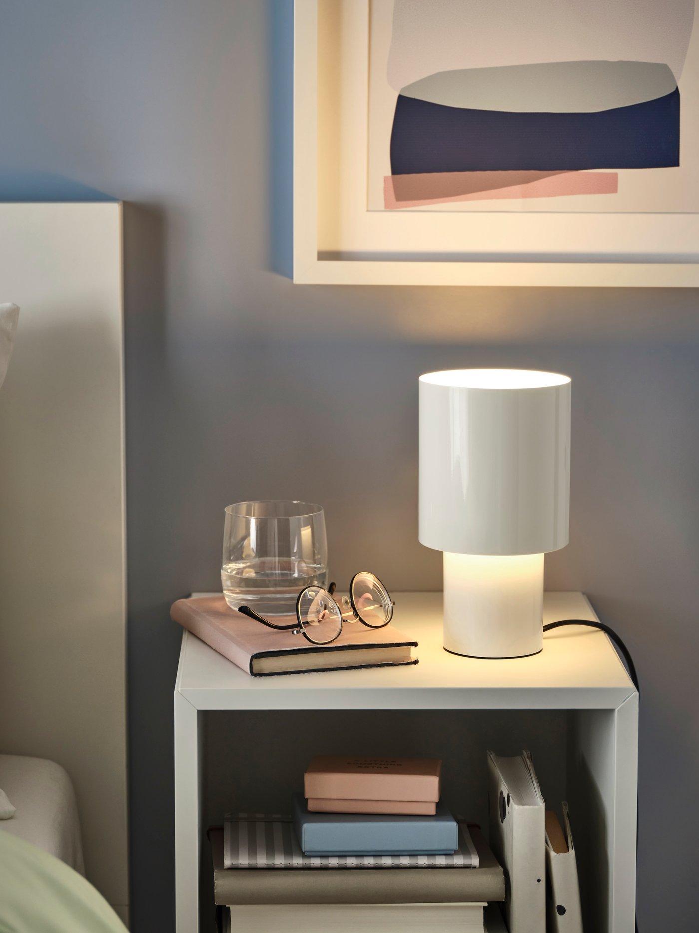 A dimmable/white SPETSBOJ table lamp in the bedroom