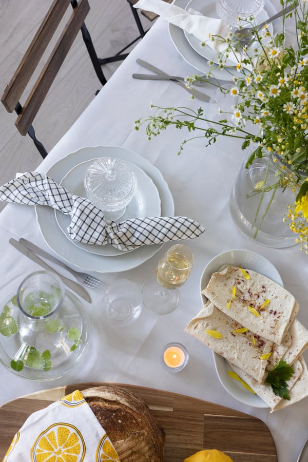 A plate with burrata and tomatoes is on the table.