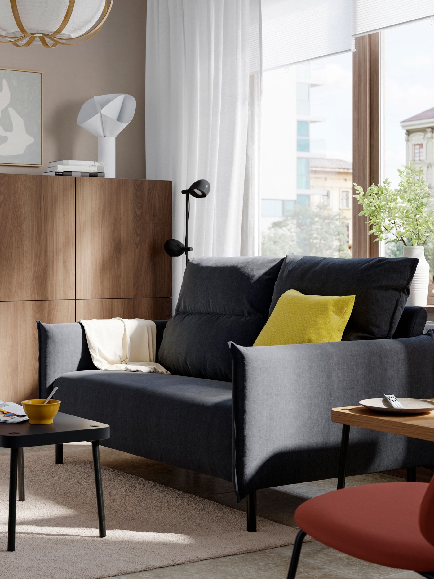 A Saxemara black-blue MANNARP 2-seat sofa in the living room