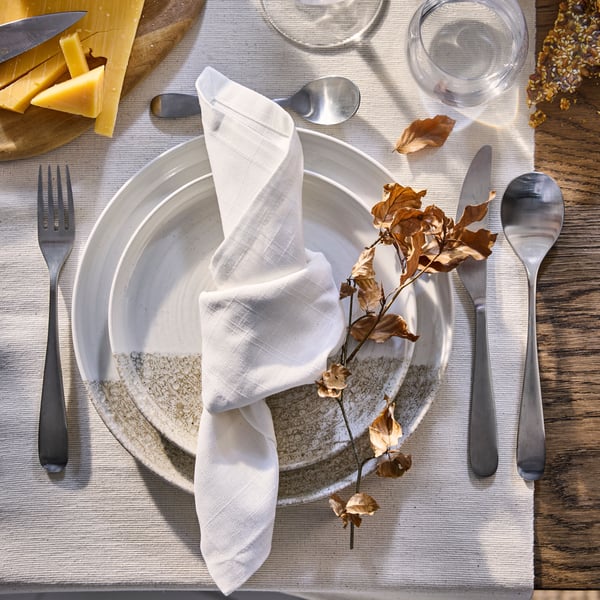 A patterned/light beige KRUSTISTEL plate in the dining room