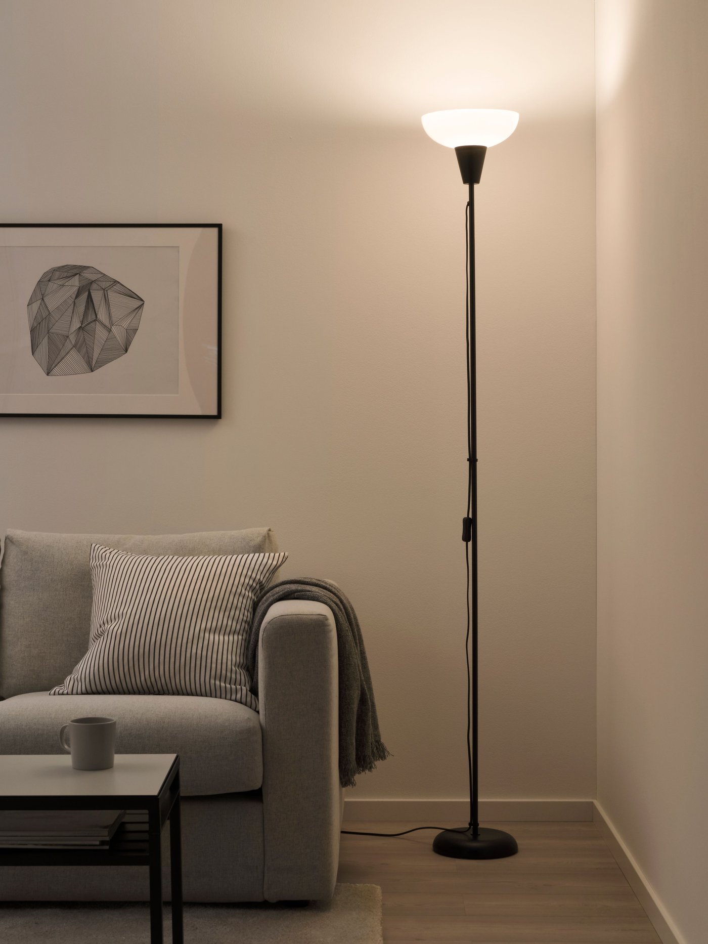 A black/white TÅGARP floor uplighter