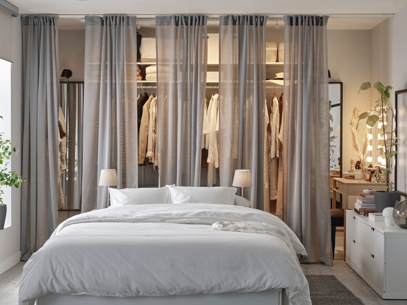 A black SKURUP wall lamp in the bedroom