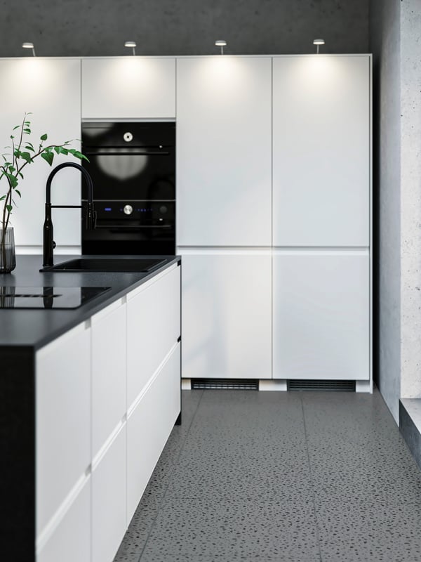 A close up of a kitchen cabinet with IKEA VOXTORP matt white doors.