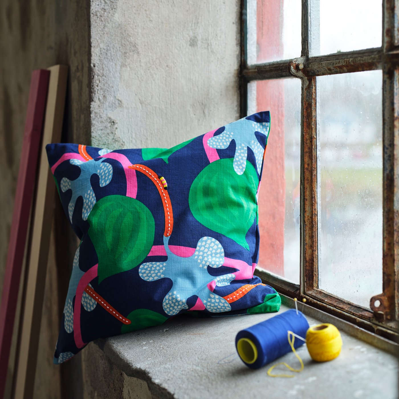 A dark blue multicolour/floral pattern MÄVINN cushion cover