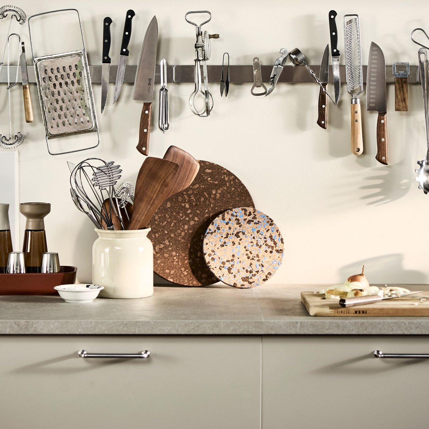 Part of a kitchen highlighting an IKEA EKBACKEN laminate worktop in grey-beige stone effect and HAVSTORP fronts in beige.