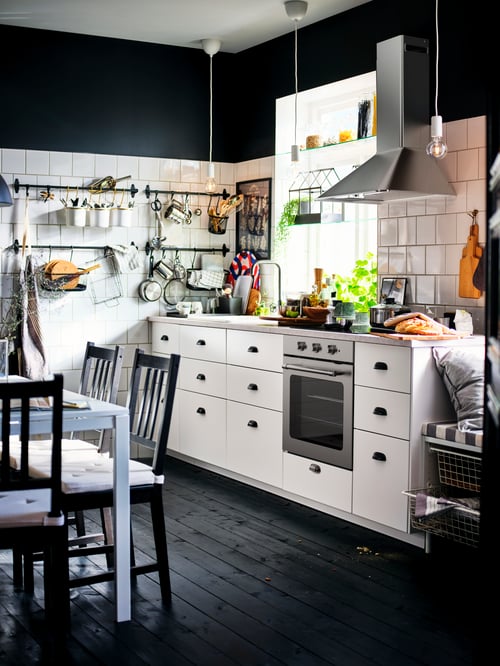 Kitchen with base cabinets with three drawers, a cabinet for oven, a base cabinet for sink with drawers, and a table.