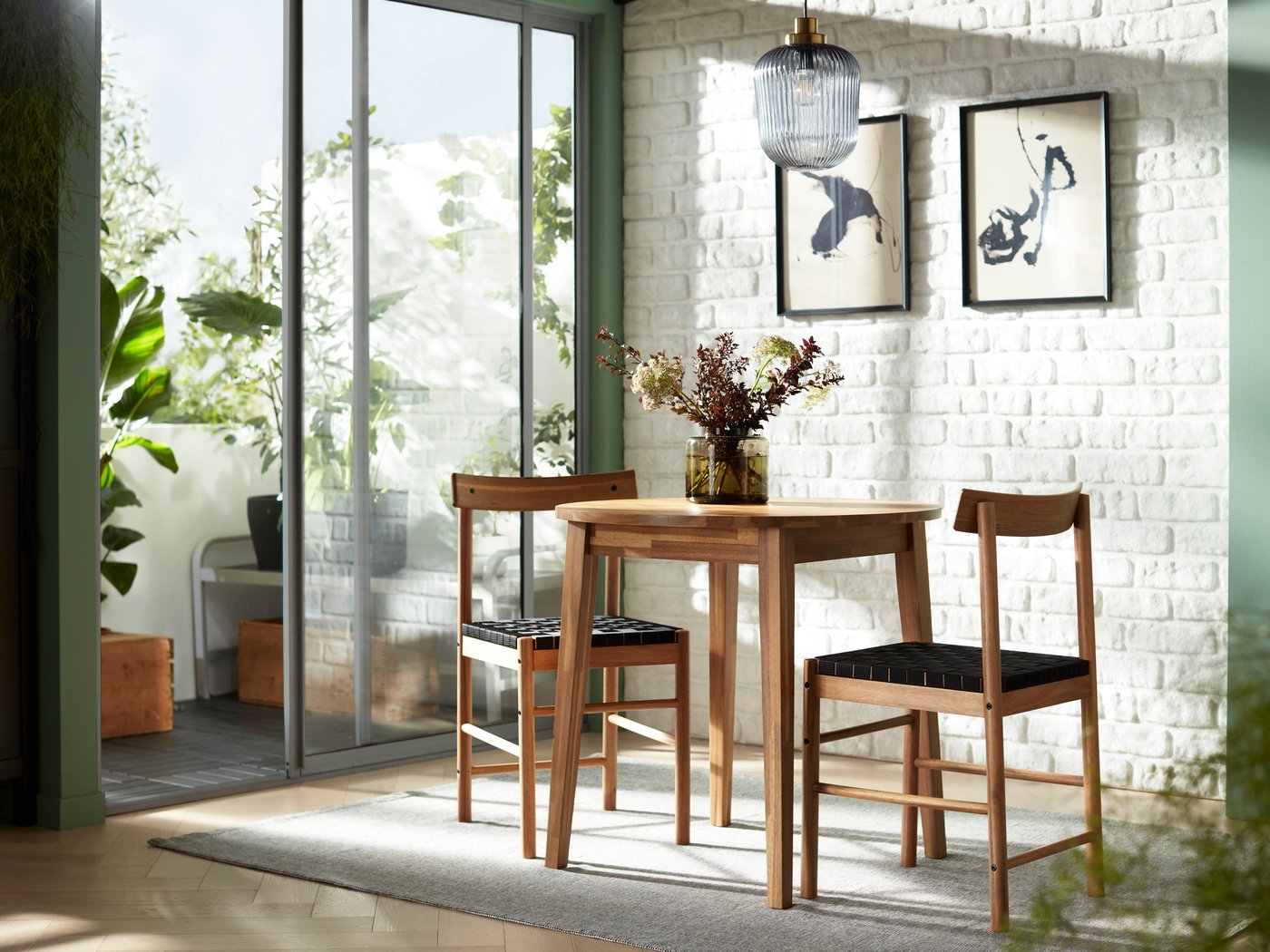 A brass/grey clear glass SOLKLINT pendant lamp in the dining room