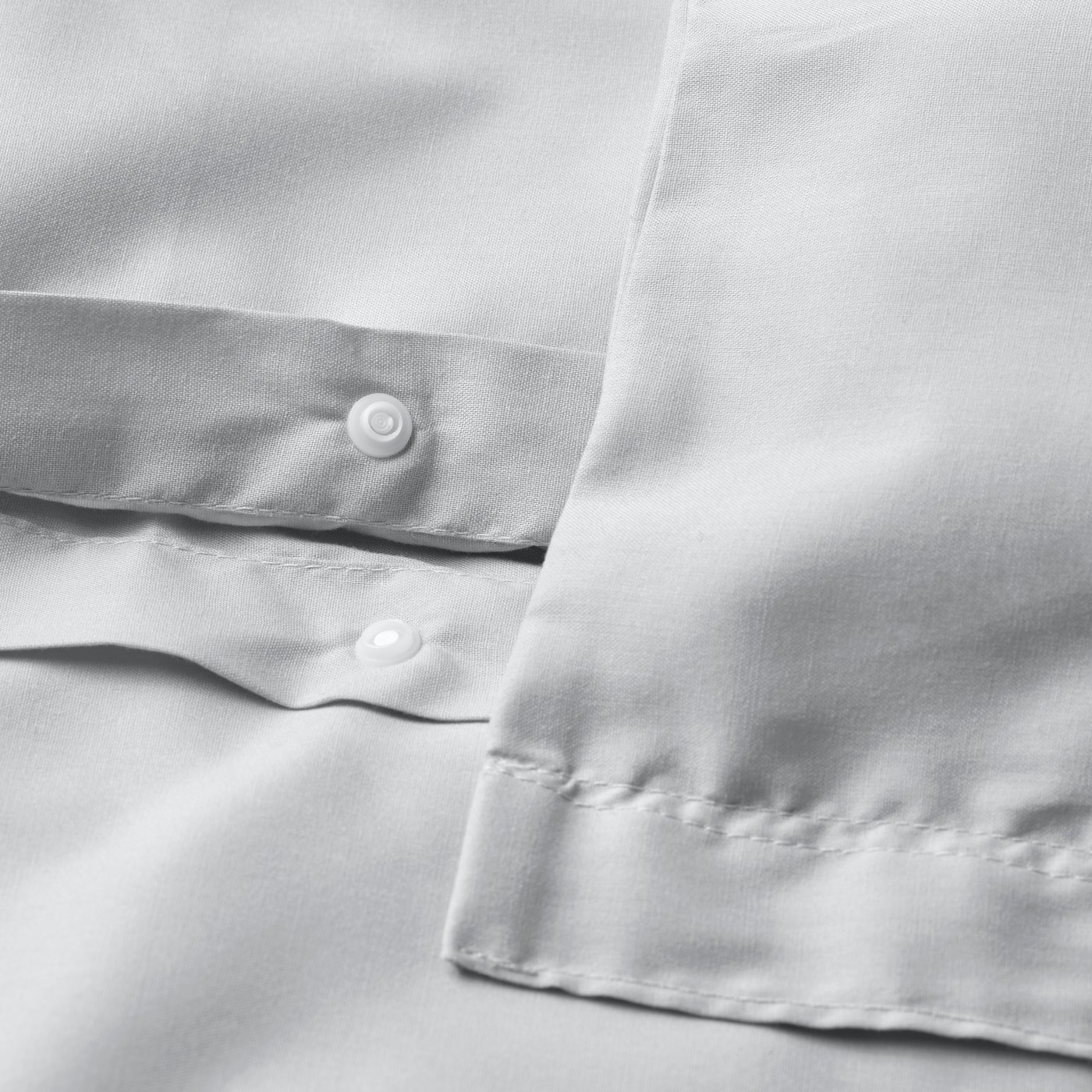 Uma capa de edredão e fronha PILTANDVINGE cinzentos.