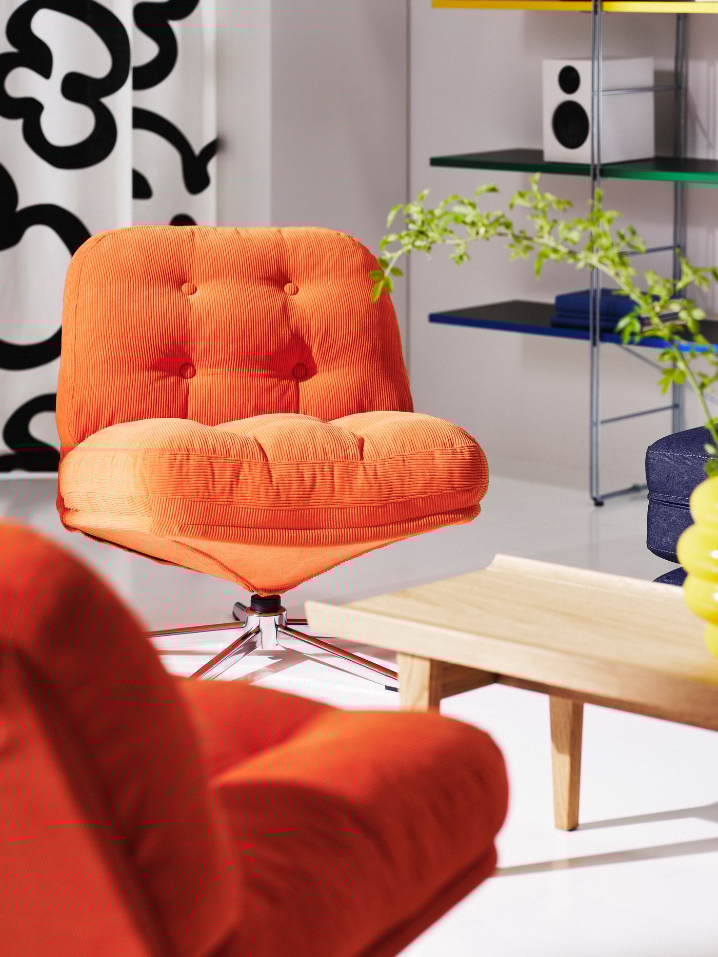 A Kelinge orange DYVLINGE swivel easy chair.
