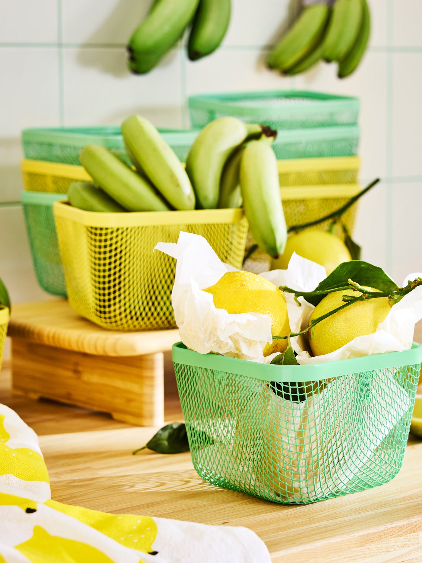 Lemons and bananas stored in green and yellow mesh IKEA 365+food storage baskets.