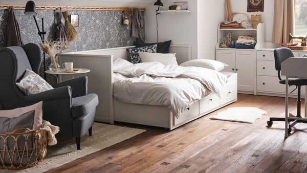 A black SKURUP floor/reading lamp in the bedroom