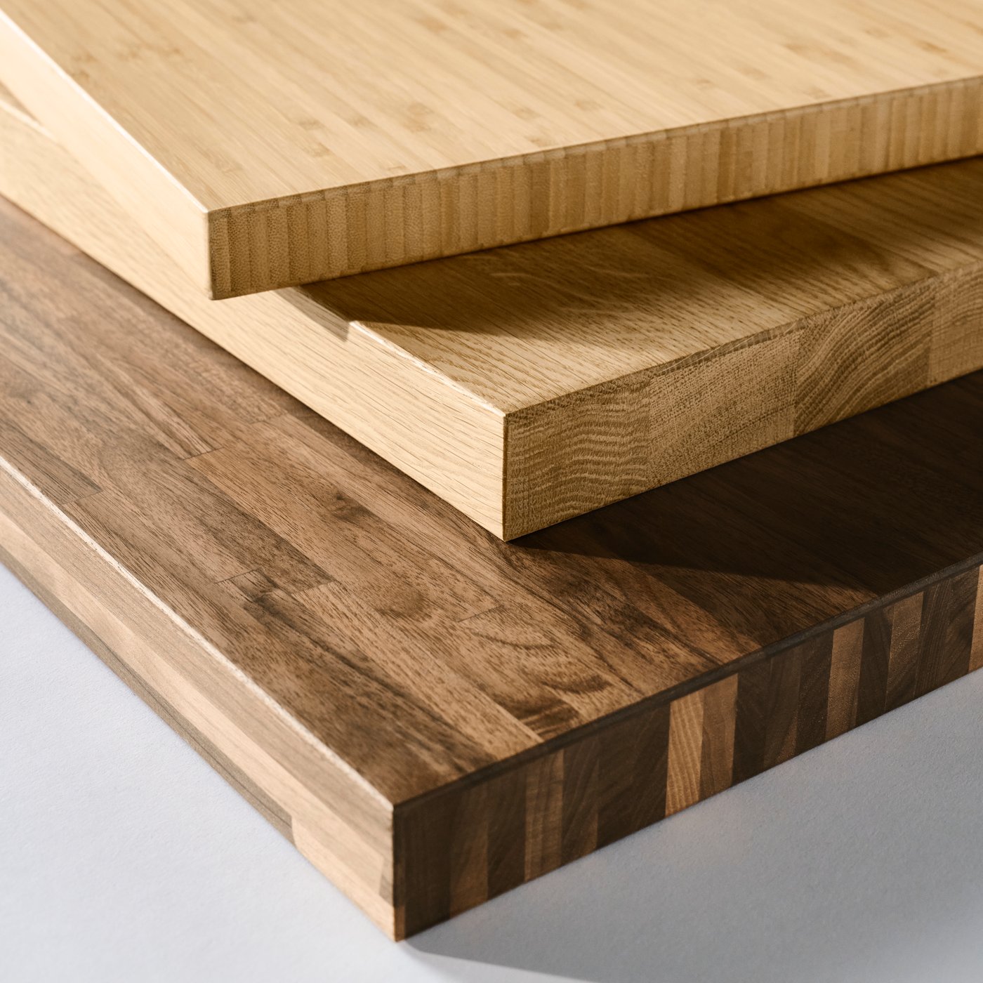 An IKEA KARLBY oak veneer worktop, an IKEA HOLMARED bamboo veneer worktop and an IKEA PINNARP walnut veneer worktop.