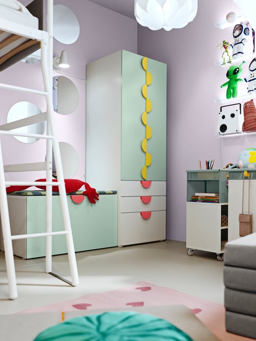 Baby and children room featuring a green SMÅSTAD storage combination with multiple yellow and red BEGRIPA handles.