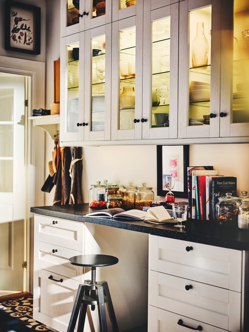 Kitchen wall with multiple wall cabinets and white base cabinets with classic white wood effect drawer fronts.