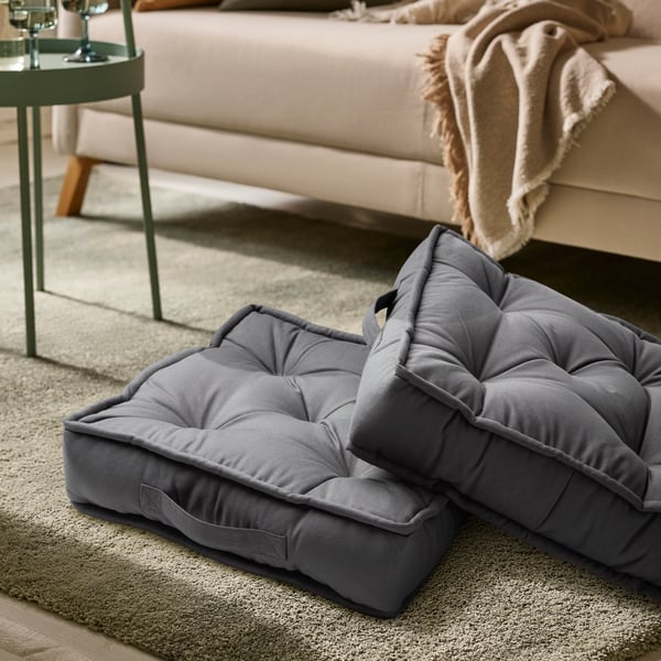 A grey GURLI floor cushion
