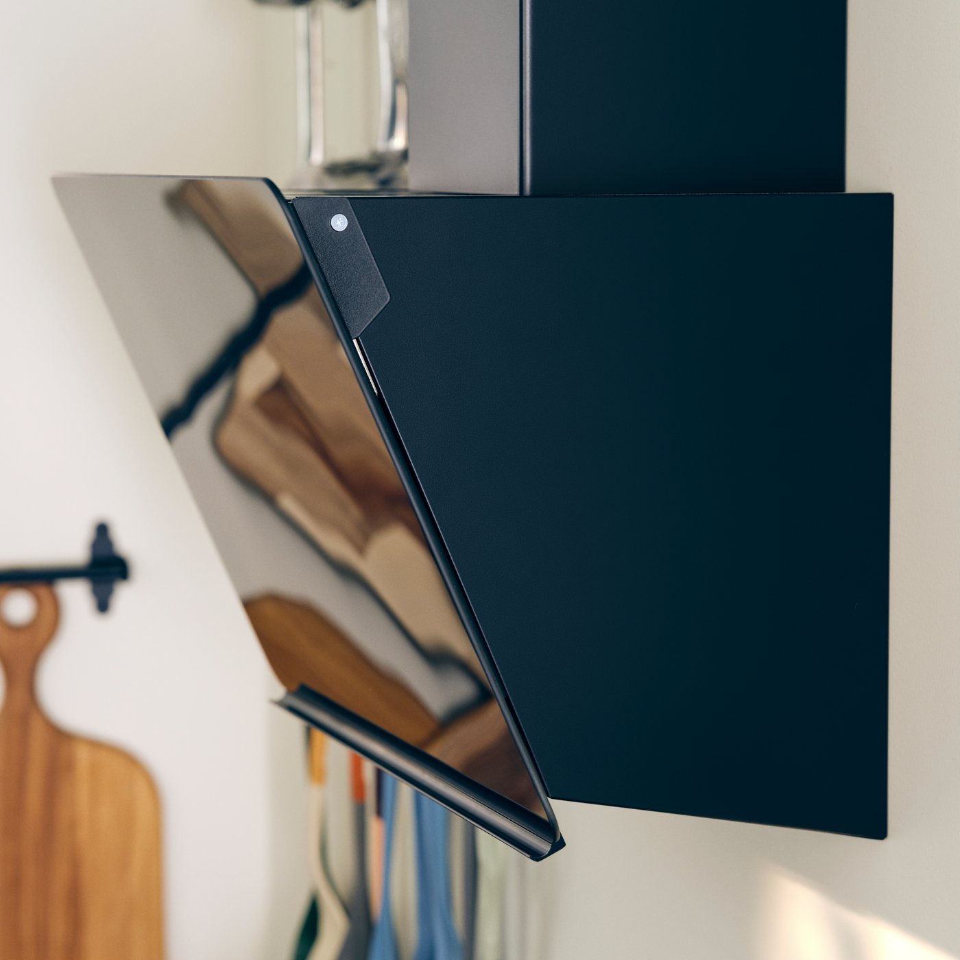 A kitchen with a black STACKBO adjustable extractor on the wall.