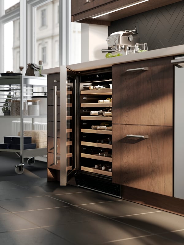 A close-up shot of a wine cooler with the glass door ajar.
