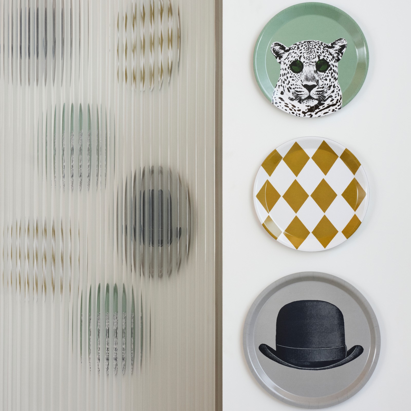 The set of three GALLERISKOG wall decorations with whimsical prints and quirky illustrations are displayed on a white wall.