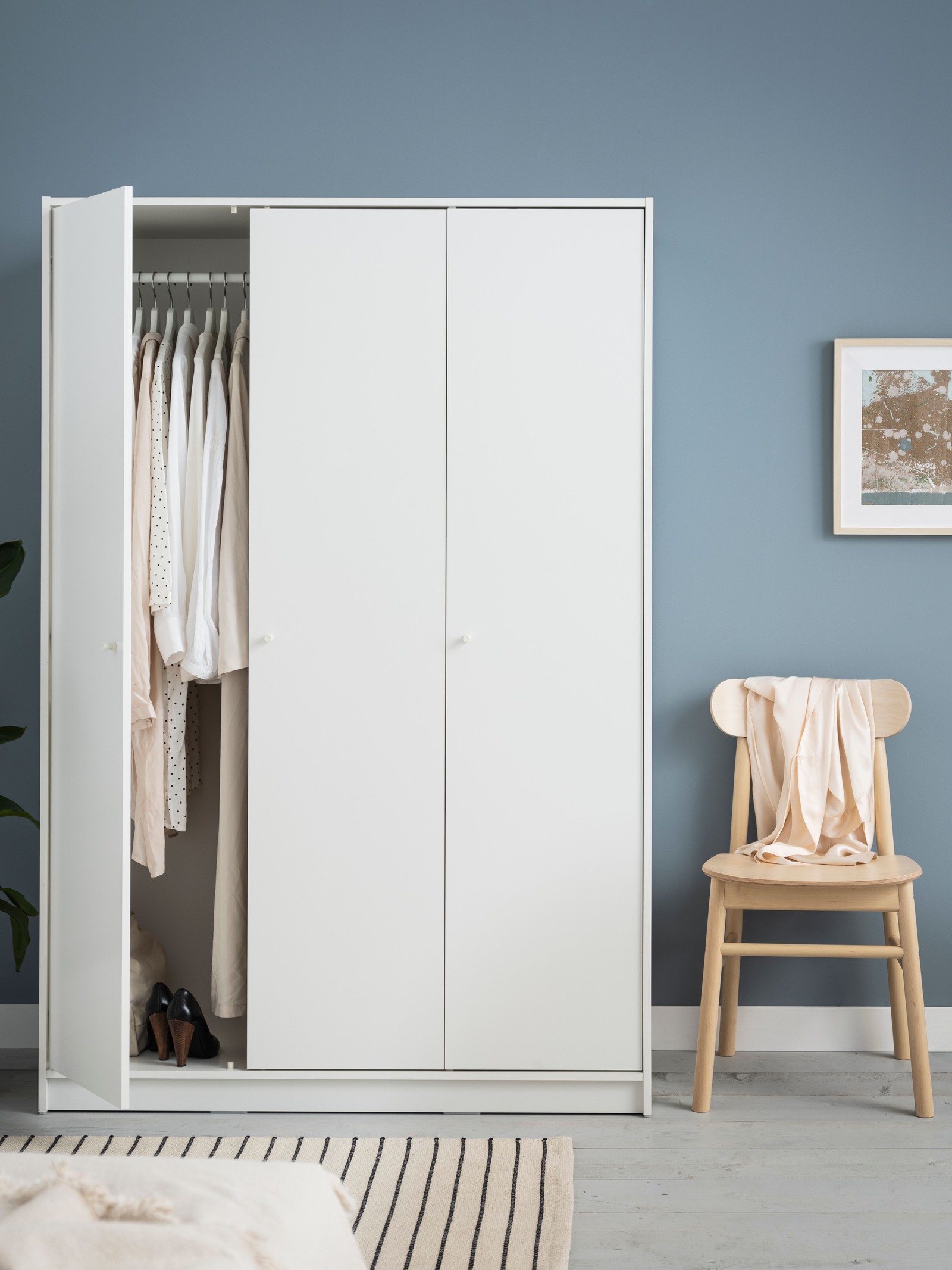A white KLEPPSTAD wardrobe with 3 doors in the bedroom
