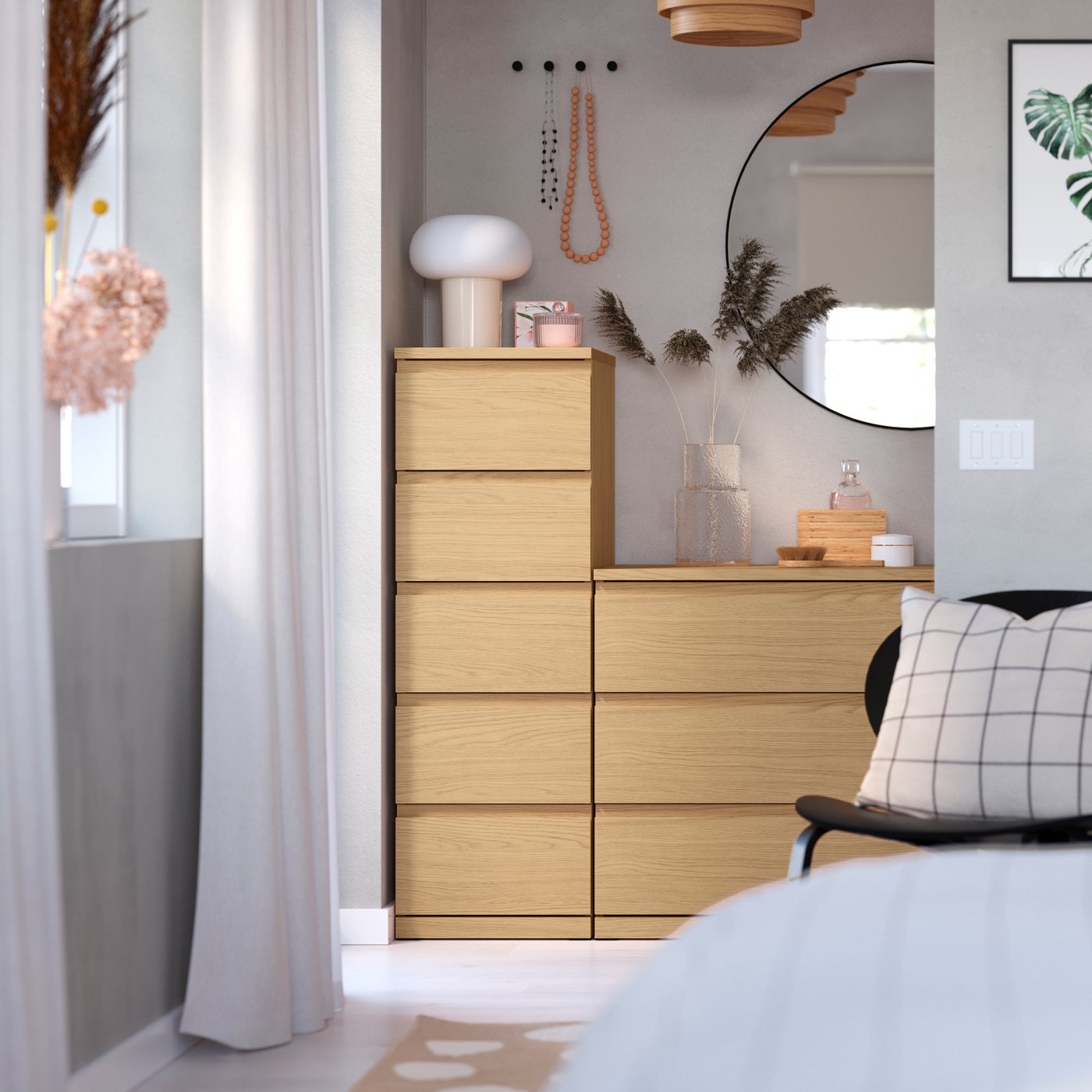 A STORKLINTA chest of 5 drawers stands side by side with a matching chest of 3 drawers near a window in a hall.