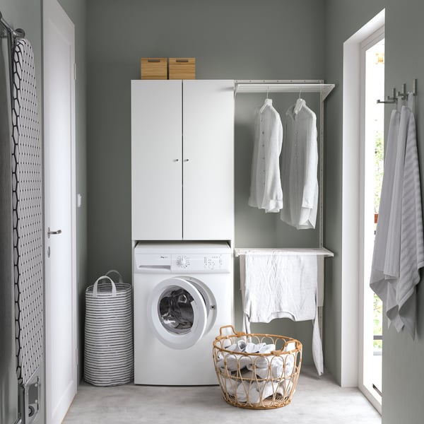A white NYSJÖN cabinet for washing machine in the laundry room