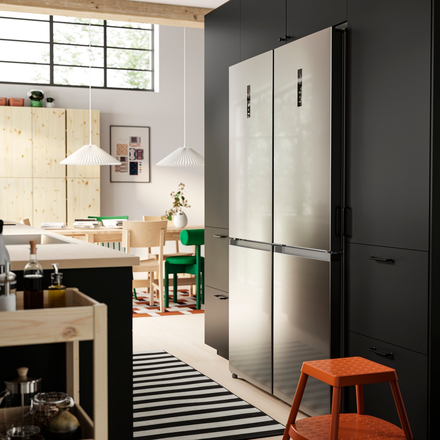 A modern kitchen with two FÖRTOFT fridge/freezers built into a wall of METOD kitchen cabinets.