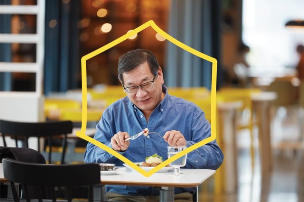 A customer eating a plate of meatballs in the Swedish Restaurant.