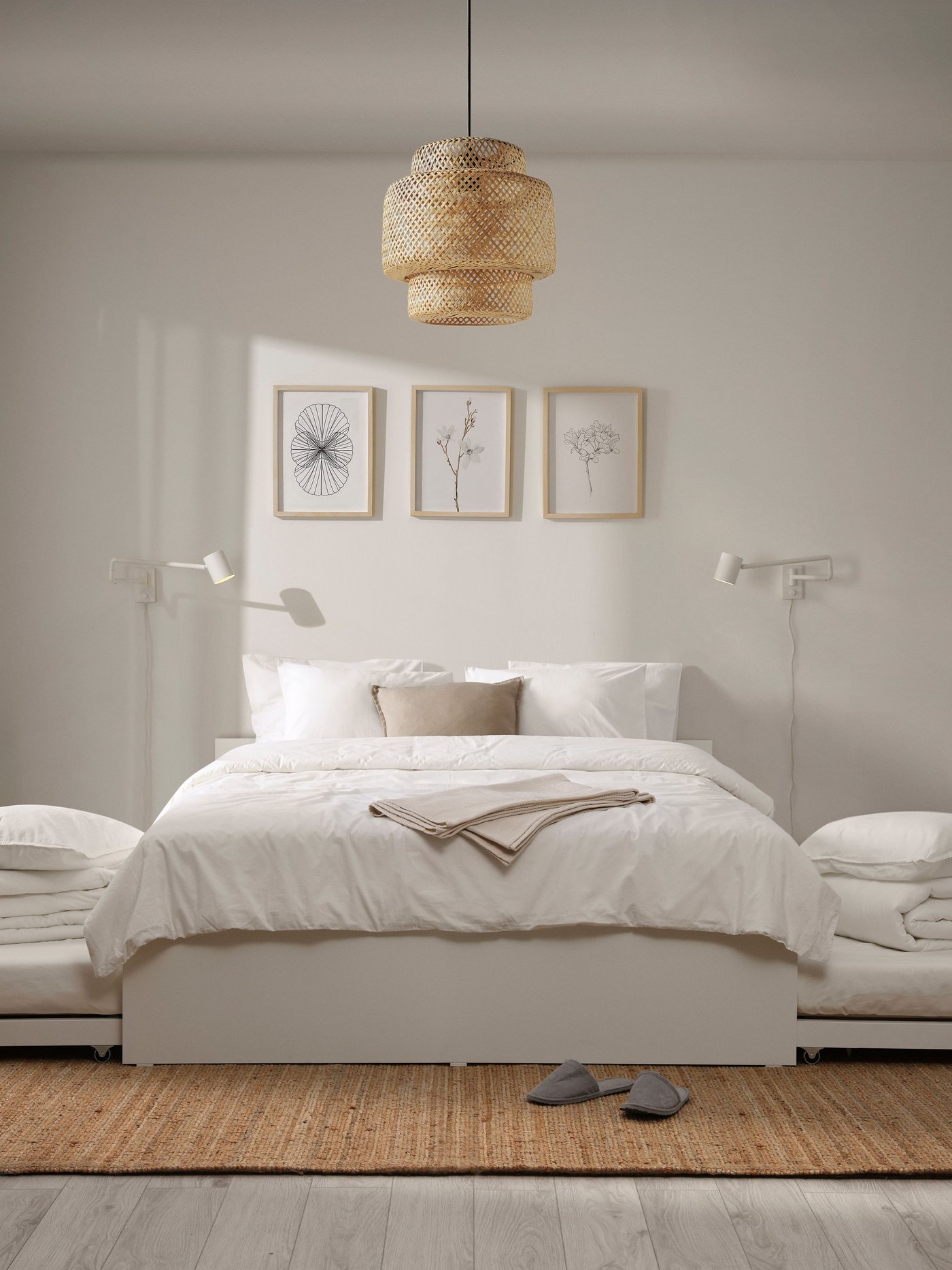 A white NYMÅNE wall lamp with swing arm