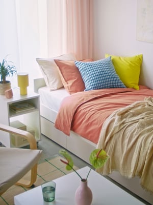 A dimmable/yellow SPETSBOJ table lamp in the bedroom