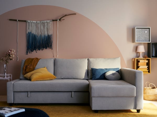 A Hyllie beige FRIHETEN corner sofa bed with storage