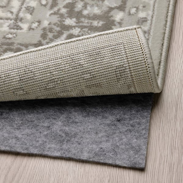 A light grey VEDBÄK rug, low pile