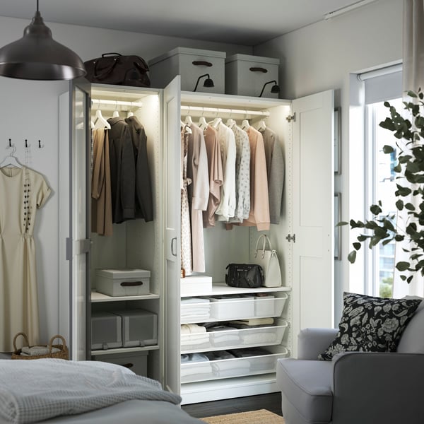 A white mirror glass/grey white PAX wardrobe combination in the bedroom