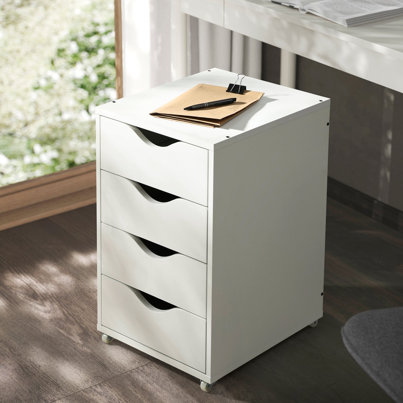 A white FRIIDROTT drawer unit on castors