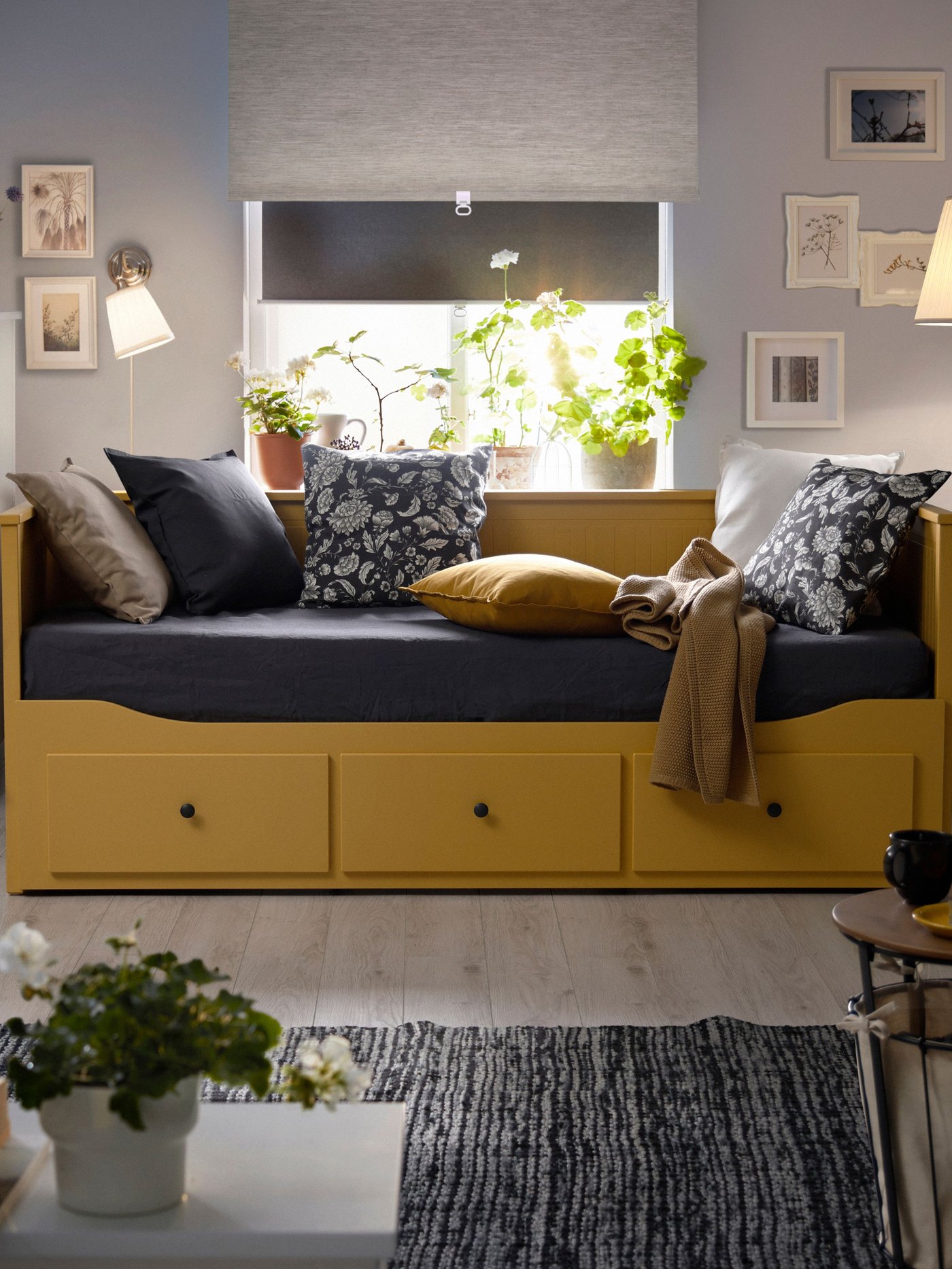 An yellow HEMNES day-bed frame with 3 drawers