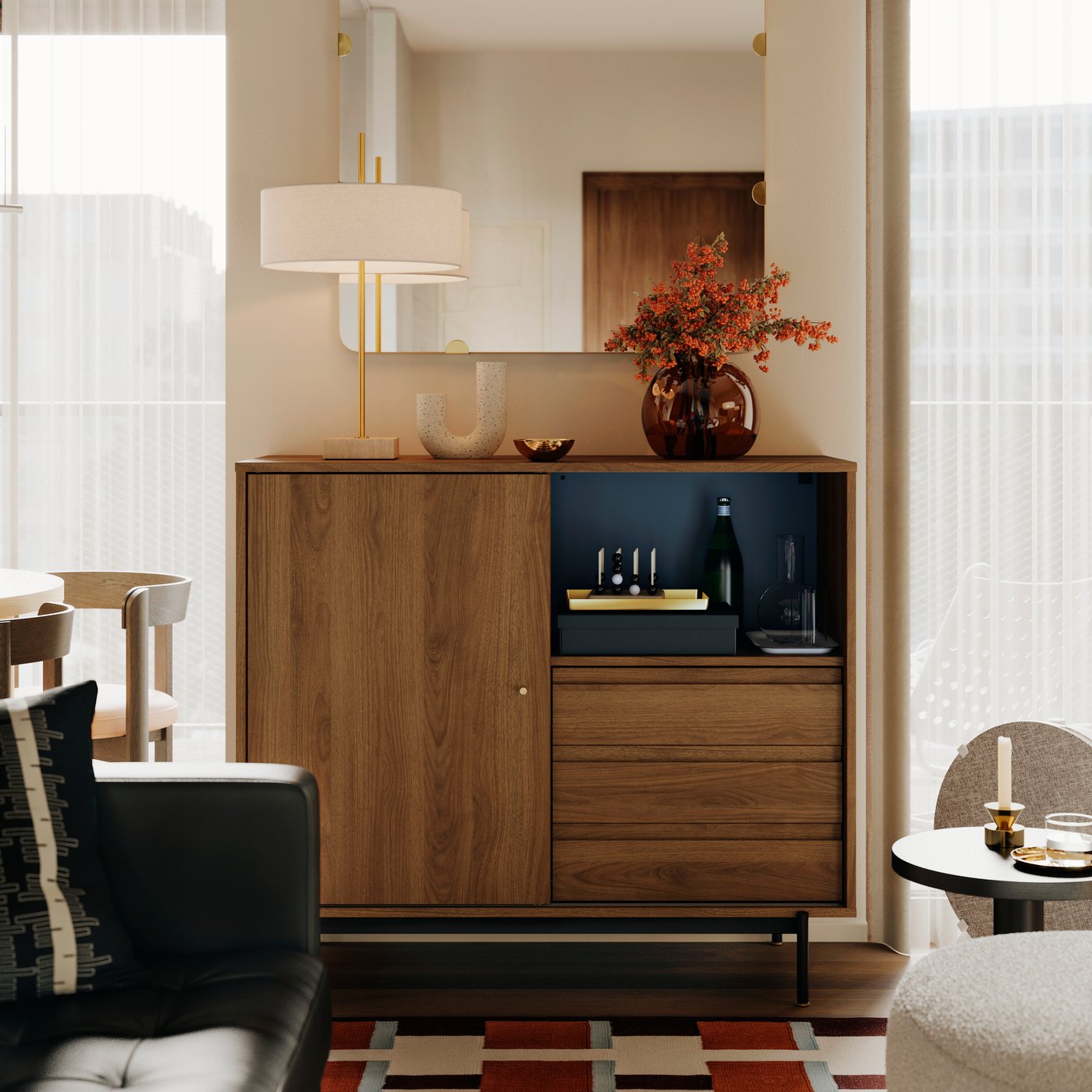 A STOCKHOLM 2025 table lamp and a STOCKHOLM 2025 vase stand on top of a RÅDMANSJÖ cabinet in an Instagram worthy living room.