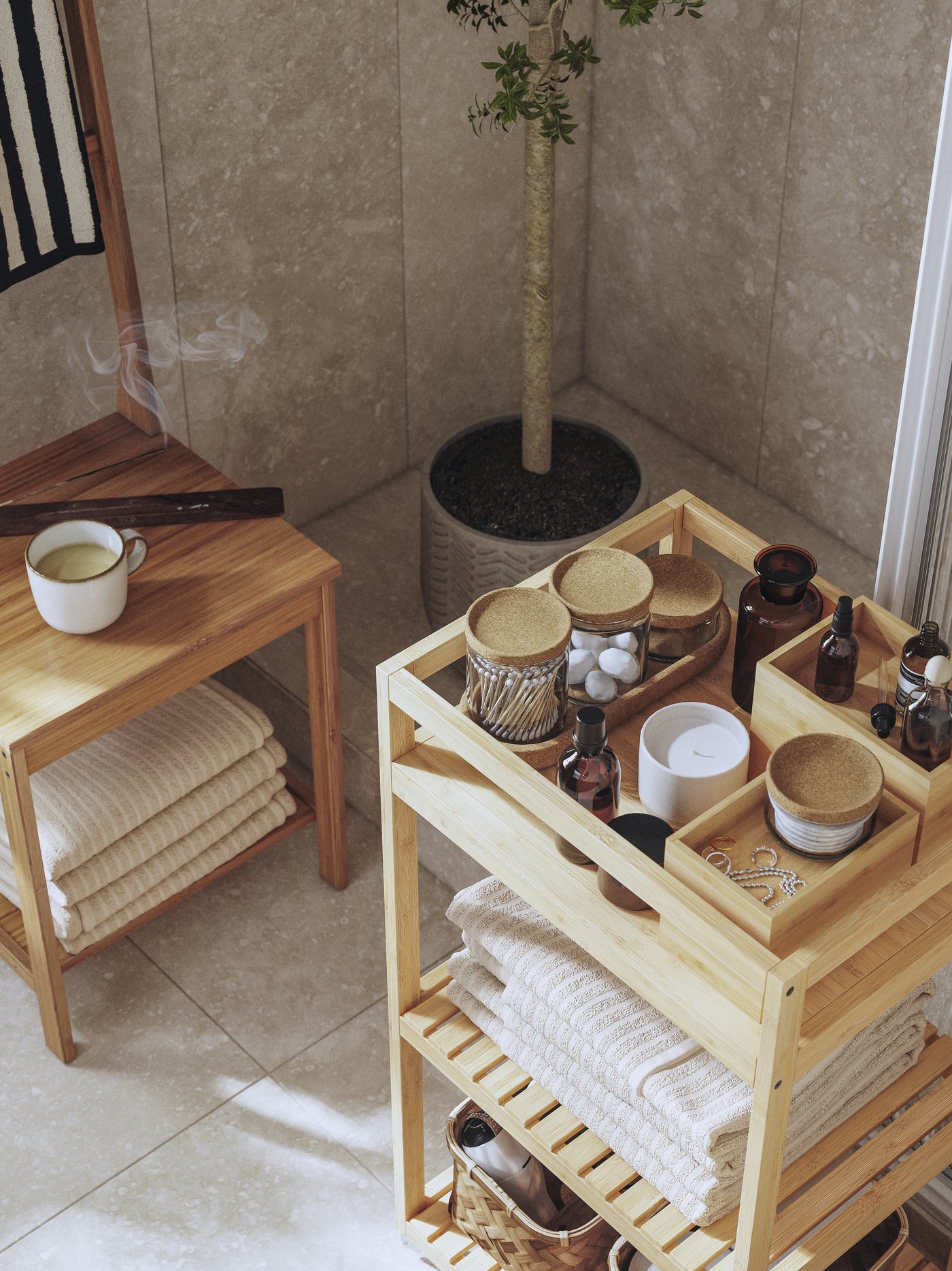 A RÅGRUND towel rack chair in bamboo with towels, a cup of tea and incense stick. A trolley with spa essentials is nearby.