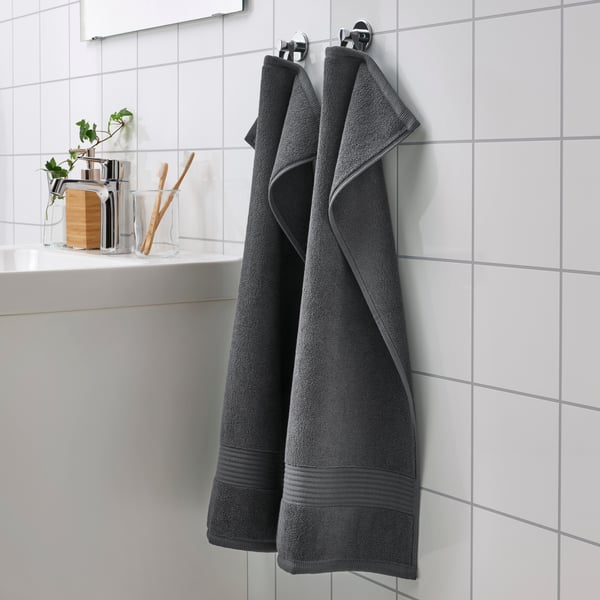 A dark grey FREDRIKSJÖN hand towel